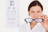 Blurred optician showing glasses
