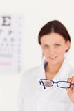Blurred optician offering glasses