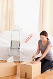 Woman packing cardboards