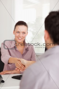 Businesswoman shakes hands with a customer