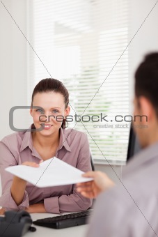 Businesswoman presenting someone a contract