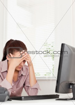 A frustrated businesswoman sitting in her office