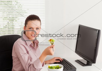 Businesswoman eats salad