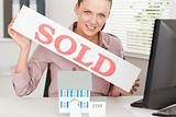 Businesswoman showing sold sign