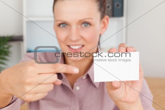 Smiling Business woman pointing at a card