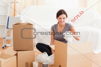 Charming woman packing her property