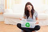 Cute woman with a recycling box