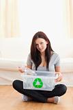 Gorgeous woman with a recycling box