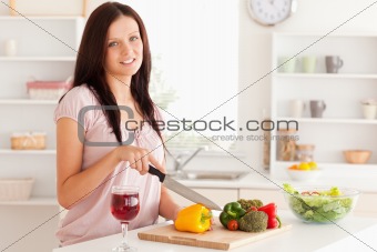 Smiling woman cutting vegetables