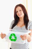 Gorgeous woman holding a recycling box