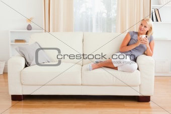 Dreaming woman holding a cup of coffee