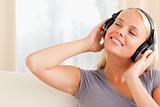 Close up of a pleased woman enjoying some music