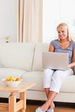Portrait of a relaxed woman holding a laptop