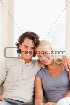 Portrait of a smiling couple sitting on a sofa