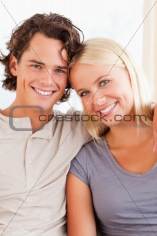 Portrait of a happy couple sitting on a sofa