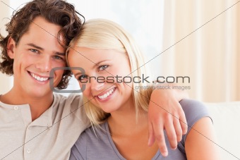 Happy couple sitting on a sofa