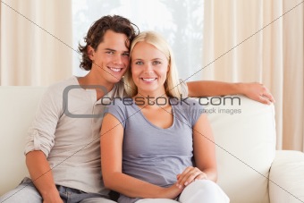 Smiling couple sitting on a sofa
