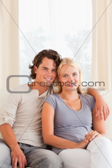 Portrait of a young couple sitting on a sofa
