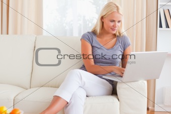 Blonde woman using a notebook