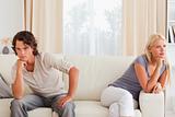 Upset couple sitting on a couch