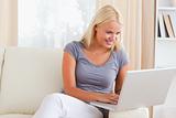 Lovely blonde woman using a laptop