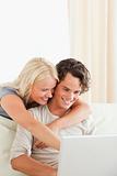 Portrait of a smiling couple using a laptop