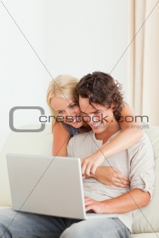 Portrait of a happy couple using a laptop