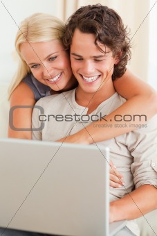 Portrait of a happy couple using a notebook