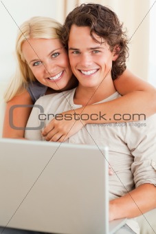 Portrait of a happy couple with a notebook