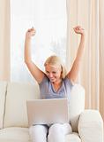 Cheerful woman using a laptop