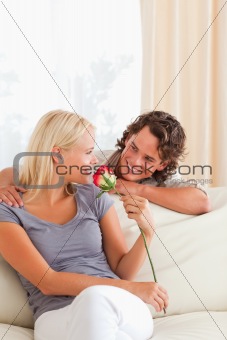 Portrait of a cute couple with a flower