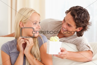 Man offering a present to his wife