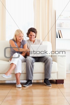 Portrait of a smiling in love couple using a laptop