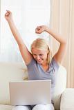 Portrait of an excited woman using a laptop