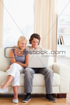 Portrait of a friendly couple using a notebook