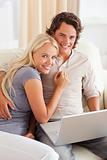 Portrait of a happy young couple using a laptop