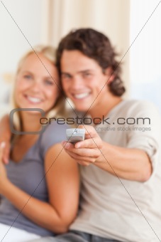 Portrait of a young couple watching TV