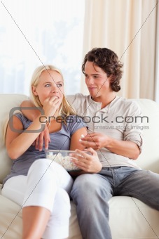 Portrait of a couple eating popcorn