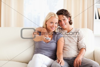 Smiling couple watching TV