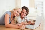 Close up of a smiling couple with a laptop