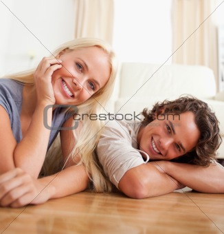Close up of a cute couple lying on the floor