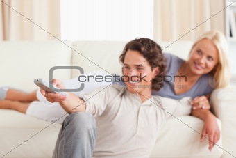 Smiling young couple watching TV