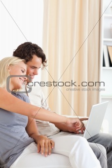 Portrait of a cute couple using a notebook