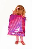 Little girl looking into a pink shopping bag
