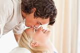 Close up of a man kissing his fiance on the forehead