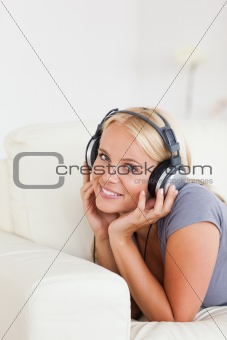 Portrait of a blonde woman listening to music