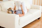 Woman listenning to music while reading a book