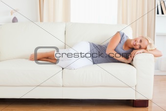 Beautiful woman resting on a sofa