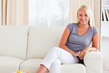 Smiling woman sitting on a sofa