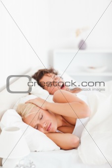 Portrait of an annoyed woman awaken by her boyfriend's snoring